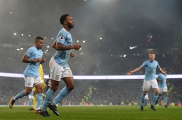Manchester City's English midfielder Raheem Sterling (C) celebrates after scoring their third goal during the English Premier League football match between Manchester City and Tottenham Hotspur at the Etihad Stadium in Manchester, north west England, on December 16, 2017. / AFP PHOTO / PAUL ELLIS / RESTRICTED TO EDITORIAL USE. No use with unauthorized audio, video, data, fixture lists, club/league logos or 'live' services. Online in-match use limited to 75 images, no video emulation. No use in betting, games or single club/league/player publications. /