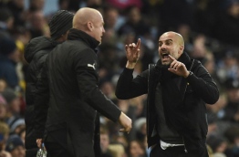 Manchester City's Spanish manager Pep Guardiola (R) gestures to Burnley's English manager Sean Dyche (L) during the English FA Cup third round football match between Manchester City and Burnley at Etihad Stadium in Manchester, north west England on January 6, 2018. / AFP PHOTO / Oli SCARFF / RESTRICTED TO EDITORIAL USE. No use with unauthorized audio, video, data, fixture lists, club/league logos or 'live' services. Online in-match use limited to 75 images, no video emulation. No use in betting, games or single club/league/player publications. /