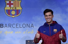 Coutinho is in Barcelona to tie up a 160-million-euro ($192 million) move from Liverpool, the third-richest deal of all time. / AFP PHOTO / Josep LAGO