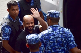 Dhiggaru MP Faris Maumoon gestures as he led away after his arrest on January 27, 2018. PHOTO: NISHAN ALI/MIHAARU