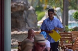 An employee of Villa's Sun Island Resort serves tourists. PHOTO: HUSSAIN WAHEED/MIHAARU
