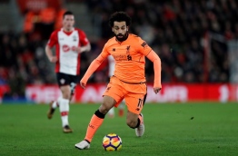Liverpool's Egyptian midfielder Mohamed Salah runs with the ball during the English Premier League football match between Southampton and Liverpool at St Mary's Stadium in Southampton, southern England on February 11, 2018. / AFP PHOTO / Adrian DENNIS / RESTRICTED TO EDITORIAL USE. No use with unauthorized audio, video, data, fixture lists, club/league logos or 'live' services. Online in-match use limited to 75 images, no video emulation. No use in betting, games or single club/league/player publications. /