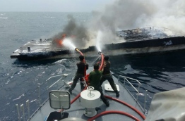 MNDF soldiers work to put out a fire on a boat near Reethi Beach Resort. PHOTO/MNDF