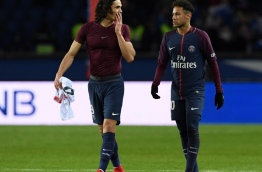 Paris Saint-Germain's Uruguayan forward Edinson Cavani (L) and Paris Saint-Germain's Brazilian forward Neymar Jr react at the end of the French Ligue 1 football match between Paris Saint-Germain (PSG) and Strasbourg at The Parc des Princes in Paris on February 17, 2018. / AFP PHOTO / CHRISTOPHE ARCHAMBAULT