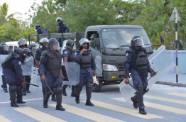 Police officers in riot gear in Hithadhoo, Addu City on February 23, 2018 --