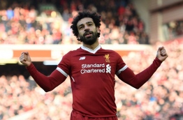 Liverpool's Egyptian midfielder Mohamed Salah celebrates scoring the team's second goal during the English Premier League football match between Liverpool and West Ham United at Anfield in Liverpool, north west England on February 24, 2018. / AFP PHOTO / Oli SCARFF / RESTRICTED TO EDITORIAL USE. No use with unauthorized audio, video, data, fixture lists, club/league logos or 'live' services. Online in-match use limited to 75 images, no video emulation. No use in betting, games or single club/league/player publications. /