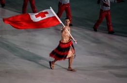 Tonga's flagbearer Pita Taufatofua leads his country's delegation during the opening ceremony of the Pyeongchang 2018 Winter Olympic Games at the Pyeongchang Stadium on February 9, 2018. / AFP PHOTO / POOL / Sean M. Haffey