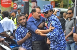 Police officers arrest Dhidhdhoo MP Abdul Latheef Mohamed at the joint opposition protest on March 2, 2018. PHOTO: HUSSAIN WAHEED/MIHAARU