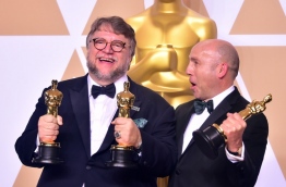 Producer and director Guillermo del Toro (L) and producter J. Miles Dale pose in the press room with the Oscar for best picture and best director for their film The Shape of Water during the 90th Annual Academy Awards on March 4, 2018, in Hollywood, California. / AFP PHOTO / FREDERIC J. BROWN
