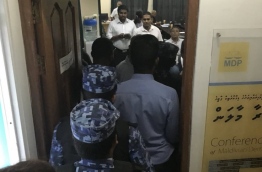 Police officers arrest three MDP members at the party's main office. PHOTO/SOCIAL MEDIA