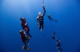 William Trubridge pictured during a free dive, with other divers accompanying him.