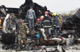 At least 40 people were killed and 23 injured when a Bangladeshi plane crashed and burst into flames near Kathmandu airport on March 12, in the worst aviation disaster to hit Nepal in years. Officials said there were 71 people on board the US-Bangla Airlines plane from Dhaka when it crashed into a football field near the airport. / AFP PHOTO / PRAKASH MATHEMA