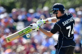 New Zealand's Mitchell Santner bats during the fifth and final ODI cricket match between New Zealand and England at Hagley Oval in Christchurch on March 10, 2018. / AFP PHOTO / Marty MELVILLE