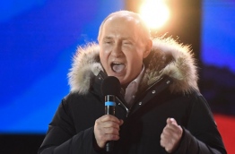 Presidential candidate, President Vladimir Putin addresses the crowd during a rally and a concert celebrating the fourth anniversary of Russia's annexation of Crimea at Manezhnaya Square in Moscow on March 18, 2018. / AFP PHOTO / Kirill KUDRYAVTSEV
