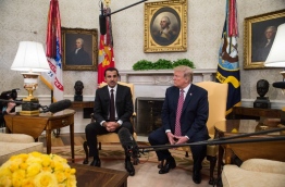 The Emir of Qatar Sheikh Tamim bin Hamad al-Thani speaks to the press with US President Donald Trump in the Oval Office at the White House in Washington, DC, on April 10, 2018. / AFP PHOTO / NICHOLAS KAMM