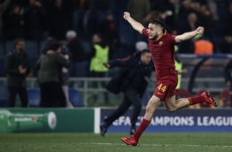 AS Roma's Greek defender Kostas Manolas celebrates after winning the UEFA Champions League quarter-final second leg football match between AS Roma and FC Barcelona at the Olympic Stadium in Rome on April 10, 2018. / AFP PHOTO / Isabella BONOTTO