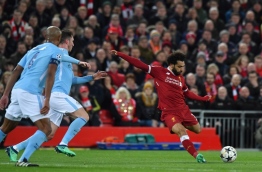 Liverpool's Egyptian midfielder Mohamed Salah takes a shot during the UEFA Champions League first leg quarter-final football match between Liverpool and Manchester City, at Anfield stadium in Liverpool, north west England on April 4, 2018. / AFP PHOTO / Anthony Devlin