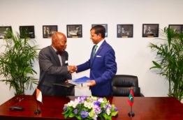 The The Permanent Representative of Maldives to the UN, Dr Ali Naseer (R) and the The Permanent Representative of Côte d’Ivoire Bernard Tanoh-Boutchoue (L) signing the joint communiqué in New York --