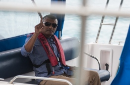 Former CP Ahmed Areef in a police launch to be taken to Dhoonidhoo after his arrest on March 6, 2018. MIHAARU PHOTO / HUSSEN WAHEED