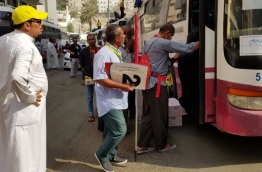 A staff of the Hajj Corporation assists Maldivians on pilgrimage to Saudi Arabia. PHOTO/HAJJ CORPORATION