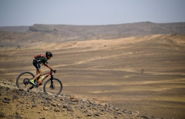 A competitor rides his bike during stage 6 of the 13th edition of the Titan Desert 2018 mountain biking race between Merzouga and Maadid on May 4, 2018. 
The Titan Desert 2018 is a 600 kilometres mountain bike race completed over six days, snaking between Boumalne Dades, at the foot-slopes of the High Atlas summits, and Erfoud, an oasis town in the Sahara Desert. / AFP PHOTO / FRANCK FIFE