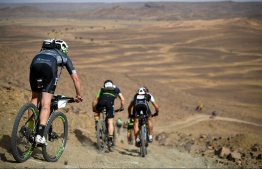 Competitors ride their bikes during stage 6 of the 13th edition of the Titan Desert 2018 mountain biking race between Merzouga and Maadid on May 4, 2018. 
The Titan Desert 2018 is a 600 kilometres mountain bike race completed over six days, snaking between Boumalne Dades, at the foot-slopes of the High Atlas summits, and Erfoud, an oasis town in the Sahara Desert. / AFP PHOTO / FRANCK FIFE