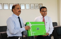 Pakistan's Ambassador for Maldives Waseem (L) gifting the 30 laptops. State minister for Education Dr.Nazeer accepting the gifts on behalf of the ministry. PHOTO/EDUCATION MINISTRY
