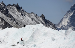 This picture taken on April 24, 2018, shows climbers at Everest Base Camp practicing their techniques on the Khumbu glacier before trying to summit Everest, some 140km northeast of the Nepali capital Kathmandu.
Everest is the ultimate mountaineering "trophy", but the rising number of inexperienced climbers attempting to tackle the summit are running huge risks to reach the top of the world. / AFP PHOTO / PRAKASH MATHEMA / 