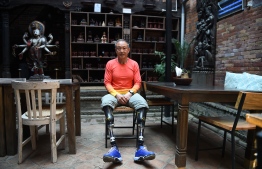 (FILES) In this file photo taken on April 04, 2018 Chinese double amputee climber Xia Boyu, who lost both of his legs during first attempt to climb Everest, pose during an interview with AFP at Bhaktapur on the outskirts of Kathmandu, ahead of another attempt to climb the mountain.
A Chinese climber who lost both legs to frostbite on Everest four decades ago reached its top on May 14 morning, becoming one of hundreds of climbers expected to summit the world's highest mountain in coming weeks. / AFP PHOTO / PRAKASH MATHEMA