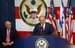 US ambassador to Israel David Friedman listens as Israel's Prime Minister Benjamin Netanyahu delivers a speech during the opening of the US embassy in Jerusalem on May 14, 2018. The United States moved its embassy in Israel to Jerusalem after months of global outcry, Palestinian anger and exuberant praise from Israelis over President Donald Trump's decision tossing aside decades of precedent. MENAHEM KAHANA / AFP