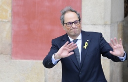The new elected Catalan regional president Quim Torra waves as he leaves the Catalan parliament after his election during a parliamentary vote session in Barcelona on May 14, 2018.
Quim Torra, a newcomer to politics who has long fiercely campaigned for independence in Catalonia, was appointed regional president today, vowing to keep fighting for an independent republic.





 / AFP PHOTO / LLUIS GENE