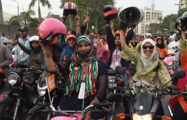 In this picture taken on May 13, 2018, Pakistani women celebrate as they ride pink motorcycles during the pink motorcycles rally in Lahore.
Punjab government launched a Pink Motorcycle Scheme with the aim to empower women in society. / AFP PHOTO / ARIF ALI