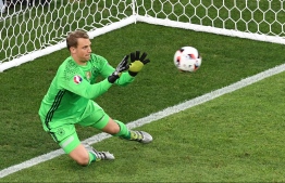 (FILES) In this file photo taken on July 7, 2016, Germany's goalkeeper Manuel Neuer stops the ball by France's forward Dimitri Payet (not pictured) during the Euro 2016 semi-final football match between Germany and France at the Stade Velodrome in Marseille.
Injured Manuel Neuer was named on May 15, 2018 in Germany's 27-man World Cup squad for the 2018 FIFA Football World Cup. / AFP PHOTO / BORIS HORVAT