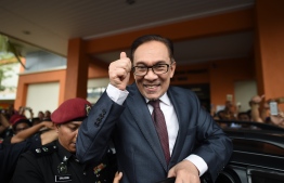 Jailed former opposition leader and current Federal opposition leader Anwar Ibrahim greets supporters after his released from the Cheras Hospital Rehabilitation in Kuala Lumpur on May 16, 2018.
The release of Anwar from prison marks yet another sharp turn in a roller-coaster political life that has left a profound mark on Malaysian politics and society. Anwar was pardoned and released on on May 16, 2018 after serving three years for a sodomy conviction widely considered a railroad job and now quashed following the stunning defeat of a Malaysian regime that had ruled for six decades.
 / AFP PHOTO / MOHD RASFAN