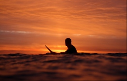 A surfer waits to catch the last wave of the day. 
PHOTO BY SARAH HALEEM @sarahhaleemphotography on FACEBOOK