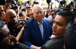 Malaysia's former prime minister Najib Razak arrives at the Malaysian Anti-Corruption Commission (MACC) office in Putrajaya on May 22, 2018. 
Scandal-tainted former Malaysian leader Najib Razak arrived on May 22 at the anti-corruption agency to give a statement over a massive financial scandal that helped to bring down his long-ruling regime in historic elections. / AFP PHOTO / Manan VATSYAYANA