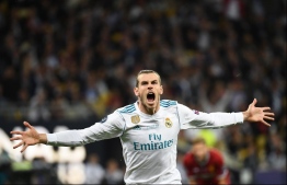 Real Madrid's Welsh forward Gareth Bale celebrates after scoring his team's second goal  during the UEFA Champions League final football match between Liverpool and Real Madrid at the Olympic Stadium in Kiev, Ukraine, on May 26, 2018. / AFP PHOTO / FRANCK FIFE