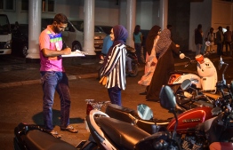A driving instructor for the "Ehlakin Mashah License" programme outside Velanage (near Huravee Building) during driving exams. PHOTO: MIHAARU
