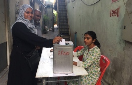 A member of main opposition MDP casts vote in a tin box after the police barred the primary election and confiscated the ballot boxes --