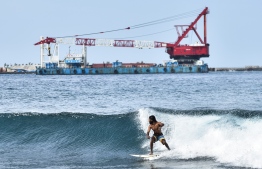 Surfing during the construction phase of the bridge; a number of local surfers have expressed their dismay upon the banning and have filed several complaints. PHOTO: MIHAARU