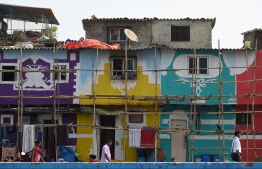 In this picture taken on June 1, 2018, Indian residents walk past murals in an area of Mumbai.
Mumbai's slums are getting a colourful makeover thanks to an organisation that aims to change how people perceive deprived areas in India's financial capital. / AFP PHOTO / PUNIT PARANJPE