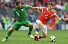Saudi Arabia's midfielder Taisir Al-Jassim (L) vies with Russia's midfielder Aleksandr Golovin during the Russia 2018 World Cup Group A football match between Russia and Saudi Arabia at the Luzhniki Stadium in Moscow on June 14, 2018. / AFP PHOTO / Francisco LEONG / 