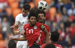 Uruguay's defender Jose Gimenez (L) rises above the Egyptian defence to head the ball and score the opening goal during the Russia 2018 World Cup Group A football match between Egypt and Uruguay at the Ekaterinburg Arena in Ekaterinburg on June 15, 2018. / AFP PHOTO / JORGE GUERRERO / 