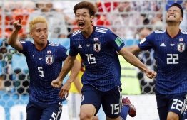 FILE PHOTO: Japan's forward Yuya Osako (C) celebrates with teammates after scoring a goal during the Russia 2018 World Cup Group H football match between Colombia and Japan at the Mordovia Arena in Saransk on June 19, 2018.  / AFP PHOTO / Jack GUEZ / 