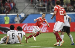 Russia's midfielder Denis Cheryshev (C) reacts after scoring the 2-0 goal during the Russia 2018 World Cup Group A football match between Russia and Egypt at the Saint Petersburg Stadium in Saint Petersburg on June 19, 2018.  / AFP PHOTO / GABRIEL BOUYS / 