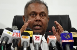 Sri Lanka's Finance Minister Mangala Samaraweera addresses a press conference to announce a 15% value added tax removal on doctors' consultation fees starting from July 1, in Colombo on June 19, 2018.   
The minister said the government will lose 1.2 billion ($7.5 million) in revenue due to the tax exemption following appeals from patients that private medical care costs were already too high. / AFP PHOTO / Ishara S. KODIKARA