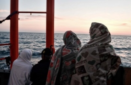 Migrants stand on the deck of the MV Aquarius, a rescue vessel chartered by SOS-Mediterranee and Doctors Without Borders (MSF Medecins Sans Frontieres), as it approaches the Italian coast on May 10, 2018.
Italy's coast guard granted authorisation for 105 migrants rescued at sea by Spanish NGO Open Arms to transfer to the Aquarius and to disembark them at the port of Catania, Sicily.   / AFP PHOTO / LOUISA GOULIAMAKI