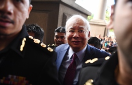 Former Malaysian prime minister Najib Razak (C) arrives for a court appearance at the Duta court complex in Kuala Lumpur on July 4, 2018.
Najib, 64, was detained on July 3 as the government of Prime Minister Mahathir Mohamad intensified a probe on corruption during his rule, including the alleged siphoning off of billions of dollars from state fund 1MDB. / AFP PHOTO / MOHD RASFAN