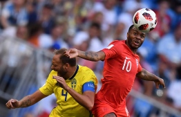 Sweden's defender Andreas Granqvist (L) heads the ball with England's forward Raheem Sterling during the Russia 2018 World Cup quarter-final football match between Sweden and England at the Samara Arena in Samara on July 7, 2018. / AFP PHOTO / Fabrice COFFRINI / 