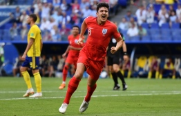 England's defender Harry Maguire celebrates after scoring the opener during the Russia 2018 World Cup quarter-final football match between Sweden and England at the Samara Arena in Samara on July 7, 2018. / AFP PHOTO / Fabrice COFFRINI / 